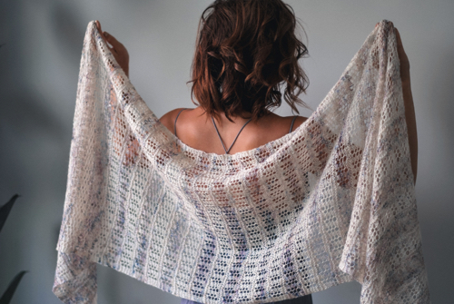 Woman holding lace shawl behind her back